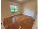 Cozy bedroom featuring a large window and unique tile flooring, creating a charming retreat at 547 Cleo Ln, Deltona, FL 32738