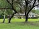 Charming single-story brick home with a lush green lawn and mature trees draped in Spanish moss at 547 Cleo Ln, Deltona, FL 32738