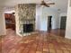 Living room features stone fireplace, and transition to kitchen at 547 Cleo Ln, Deltona, FL 32738