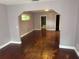 Open living room with wood floors, natural light, and neutral paint, offering a flexible layout at 547 Cleo Ln, Deltona, FL 32738