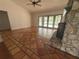 Living room boasts tile floors, stone fireplace, and views of the pool at 547 Cleo Ln, Deltona, FL 32738