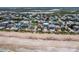 Aerial view of homes near the beach. Enjoy beachfront living and close proximity to community and surrounding landscapes at 6320 S Atlantic Ave, New Smyrna Beach, FL 32169