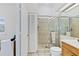 Bathroom featuring tiled shower with glass doors, toilet and single sink vanity at 6320 S Atlantic Ave, New Smyrna Beach, FL 32169