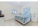 Bedroom features a queen size bed, neutral walls, shutters on the window and modern lamps at 6320 S Atlantic Ave, New Smyrna Beach, FL 32169