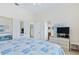 Bedroom showing bathroom access, mirrored closet, and TV at 6320 S Atlantic Ave, New Smyrna Beach, FL 32169