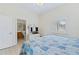 Bedroom features a queen size bed, bathroom access, TV and shutters on the window at 6320 S Atlantic Ave, New Smyrna Beach, FL 32169