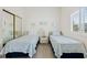 Bright bedroom featuring twin beds, neutral walls and a closet with mirrored doors at 6320 S Atlantic Ave, New Smyrna Beach, FL 32169