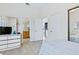 Bedroom showing bathroom and laundry access, mirrored closet, and TV at 6320 S Atlantic Ave, New Smyrna Beach, FL 32169