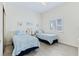 Bedroom with two twin beds, shuttered window and ceiling fan at 6320 S Atlantic Ave, New Smyrna Beach, FL 32169