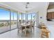 Cozy dining area with views of the ocean and a sliding door to the deck at 6320 S Atlantic Ave, New Smyrna Beach, FL 32169