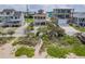 Coastal home near the beach, featuring a spacious driveway and lush landscaping providing a serene setting at 6320 S Atlantic Ave, New Smyrna Beach, FL 32169