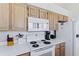 Efficiently designed kitchen featuring white appliances and ample counter space for cooking prep at 6320 S Atlantic Ave, New Smyrna Beach, FL 32169