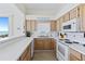Functional kitchen with sleek white countertops, essential appliances, and beach view at 6320 S Atlantic Ave, New Smyrna Beach, FL 32169