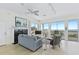 Bright living room with large windows overlooking the ocean, fireplace, and comfortable seating at 6320 S Atlantic Ave, New Smyrna Beach, FL 32169