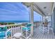 Charming covered porch with comfortable seating and ocean views offers an inviting outdoor space at 6320 S Atlantic Ave, New Smyrna Beach, FL 32169
