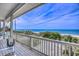 Enjoy serene ocean views from this covered porch with stairs leading down to the beach at 6320 S Atlantic Ave, New Smyrna Beach, FL 32169