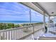 Relaxing covered porch features stunning ocean views beyond well-maintained native plants at 6320 S Atlantic Ave, New Smyrna Beach, FL 32169
