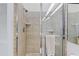 Close-up of tiled shower with glass doors, towel rack and tiled floor at 6320 S Atlantic Ave, New Smyrna Beach, FL 32169