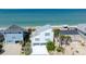 Stunning aerial view of a beachfront home with a metal roof and easy beach access at 6871 S Atlantic Ave., New Smyrna Beach, FL 32169