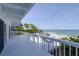 White railing deck overlooking the ocean, providing a serene space with seating and dining options at 6871 S Atlantic Ave., New Smyrna Beach, FL 32169