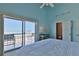 Bright bedroom with ocean view, balcony access, and ensuite bathroom for a relaxing coastal retreat at 6871 S Atlantic Ave., New Smyrna Beach, FL 32169