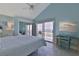 Bedroom featuring ocean view balcony access, tile floors, and desk work area at 6871 S Atlantic Ave., New Smyrna Beach, FL 32169
