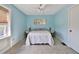 Bedroom featuring natural light, tile flooring, and coastal-inspired wall art at 6871 S Atlantic Ave., New Smyrna Beach, FL 32169