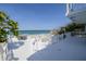 Inviting white deck featuring ample seating and scenic views of the ocean at 6871 S Atlantic Ave., New Smyrna Beach, FL 32169