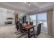 Dining area with modern table and chairs and sliding glass doors to the outdoor deck at 6871 S Atlantic Ave., New Smyrna Beach, FL 32169
