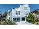Light blue beach house with white trim, elevated for parking and showcasing coastal charm at 6871 S Atlantic Ave., New Smyrna Beach, FL 32169