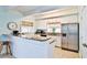 Well-lit kitchen with stainless steel appliances, granite counters, and a breakfast bar at 6871 S Atlantic Ave., New Smyrna Beach, FL 32169