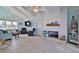 Spacious living room with high ceilings, a fireplace, and large windows with natural light at 6871 S Atlantic Ave., New Smyrna Beach, FL 32169