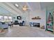 Open-concept living room with vaulted ceilings, shiplap fireplace, and bright windows offering serene views at 6871 S Atlantic Ave., New Smyrna Beach, FL 32169
