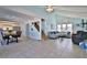 Open-concept living space featuring tile floors, vaulted ceilings, and comfortable seating at 6871 S Atlantic Ave., New Smyrna Beach, FL 32169
