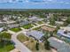 An aerial view reveals a charming neighborhood with mature trees, single-story homes, and serene streets at 7 Heather Ln, Ormond Beach, FL 32174