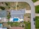 Aerial view of the property featuring a swimming pool, backyard patio, and long driveway at 7 Heather Ln, Ormond Beach, FL 32174