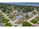 An aerial view displays homes in a beautiful neighborhood with mature trees near a body of water at 7 Heather Ln, Ormond Beach, FL 32174