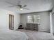 This bedroom offers neutral carpeting, a ceiling fan, and a stylish dresser at 7 Heather Ln, Ormond Beach, FL 32174