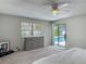 Cozy bedroom featuring carpeting, a ceiling fan, and a sliding glass door to the pool at 7 Heather Ln, Ormond Beach, FL 32174