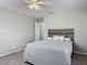 Bedroom featuring a cozy bed, soft carpet, a ceiling fan, and ample natural light at 7 Heather Ln, Ormond Beach, FL 32174