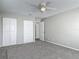 Spacious bedroom with neutral carpet, a ceiling fan, and two closets for ample storage at 7 Heather Ln, Ormond Beach, FL 32174