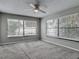 Spacious bedroom with neutral carpet, a ceiling fan, and ample natural light from large windows at 7 Heather Ln, Ormond Beach, FL 32174
