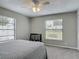 Comfortable bedroom featuring a plush bed, carpeted floors, a ceiling fan, and bright natural light at 7 Heather Ln, Ormond Beach, FL 32174