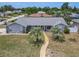 Charming single-story home boasts lush landscaping, a well-manicured lawn, and a welcoming walkway at 7 Heather Ln, Ormond Beach, FL 32174