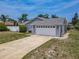 Garage with a double door, concrete driveway, and light gray siding at 7 Heather Ln, Ormond Beach, FL 32174