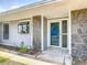 A well-maintained front entrance features stone accents, clean landscaping, and a storm door at 7 Heather Ln, Ormond Beach, FL 32174