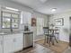 Bright kitchen featuring white cabinets, granite countertops, stainless steel appliances, and a cozy breakfast nook at 7 Heather Ln, Ormond Beach, FL 32174