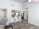 Open-concept living room featuring a breakfast bar and wood-look flooring at 7 Heather Ln, Ormond Beach, FL 32174