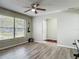 The living room features vinyl floors, a ceiling fan, large windows, and neutral-colored walls at 7 Heather Ln, Ormond Beach, FL 32174