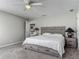 Comfortable main bedroom with wood furniture, carpeting, and en suite kitchen access at 7 Heather Ln, Ormond Beach, FL 32174
